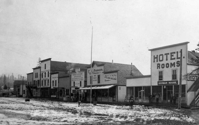 Bovill Main Street, lined with stores and with some snow on the ground.