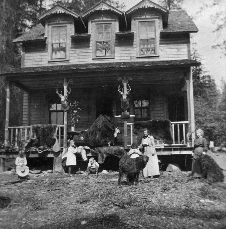 Gwen, Dorothy, Mrs. Bovill, and others standing in front of a new house at Warren Meadows.