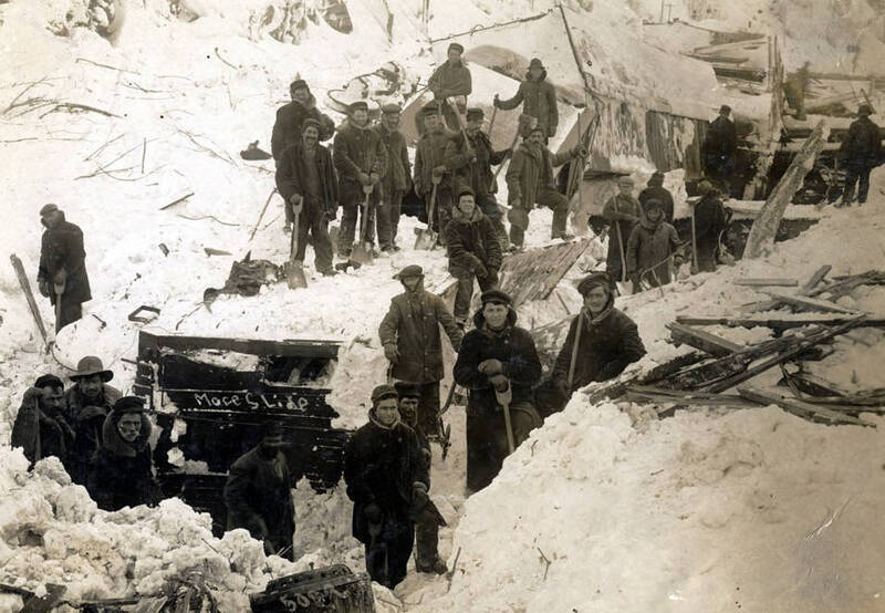 Men digging buildings out of snow from snowslide. Mace, Idaho.