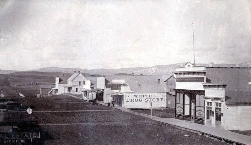 Corner of First and Main Streets. White's Drug Store, Justice of the Peace, W.J. McConnell & Co., Bank Exchange, Restaurant and Bakery. Moscow, Idaho.