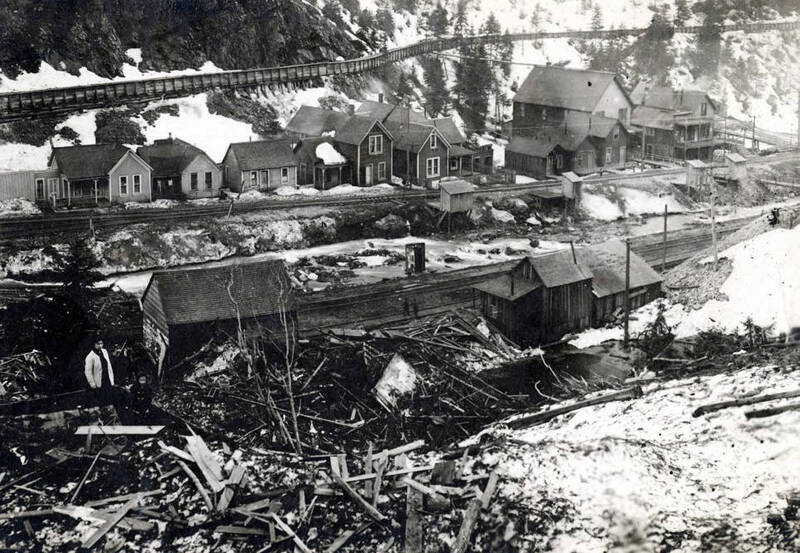After the snowslide, shows some of the undamaged homes in background. Mace, Idaho.