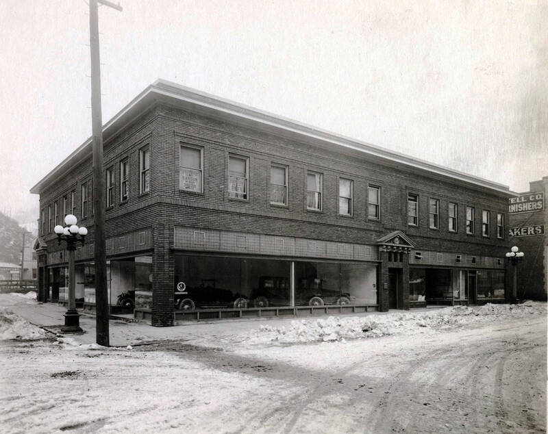 Automobiles in showroom. Also shown are offices of Dr. Leonard E. Hanson and osteopath, James A. Savage