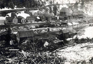 After the snowslide, shows some of the undamaged homes in background. Mace, Idaho.