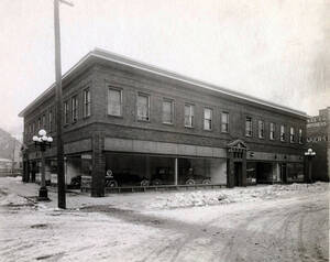 Automobiles in showroom. Also shown are offices of Dr. Leonard E. Hanson and osteopath, James A. Savage