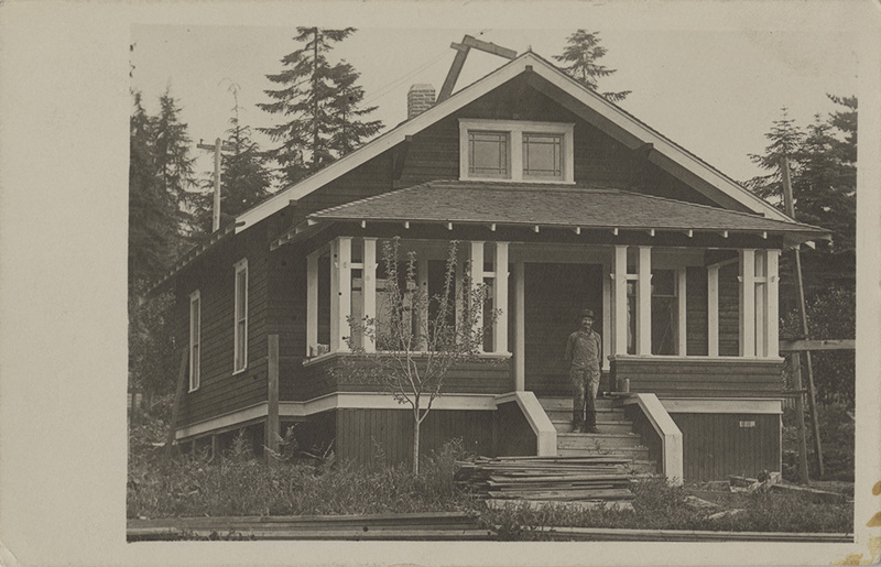 Postcard of a man standing in front of an unidentified home.