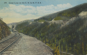 Postcard of railroad tracks in a mountain pass. Possibly the Chicago, Milwaukee, St. Paul and Pacific Railroad (often referred to as the Milwaukee Road) in Idaho.