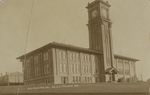 Photographic postcard of Bryan Hall on the Washington State University campus (mislabeled "Noll Aduitorium") . Card is damaged and held together with tape.