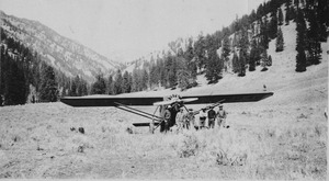 Noel Routson, Dave Lewis and others with the first airplane that flew out of the upper airstrip at Cabin Creek
