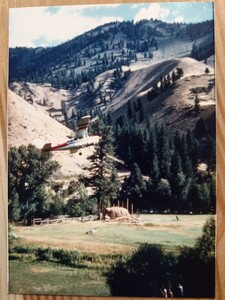 View of a plane from Arnold Aviation flying over the hay barn, in construction at they Taylor Wilderness Research Station
