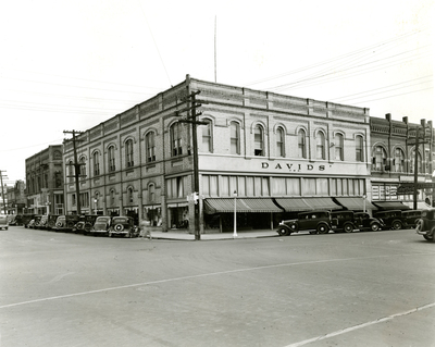 Davids' department store exterior showing streets and parked cars.