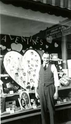 The manager of Ben Franklin standing in front of a window display