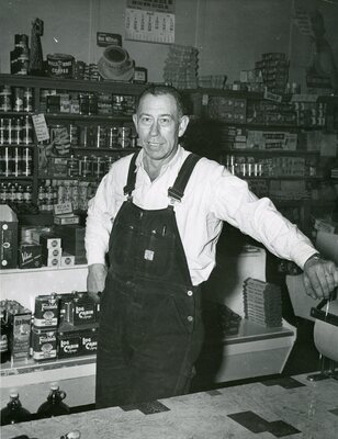 Grocery store interior and unknown man posing