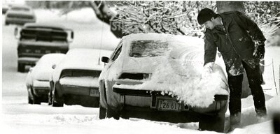 Clearing a Snow Covered Car