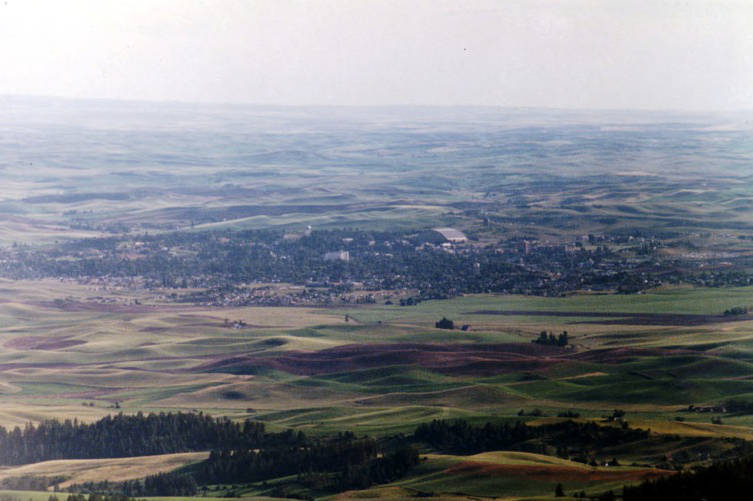 rolling green hills surround a small town and university campus