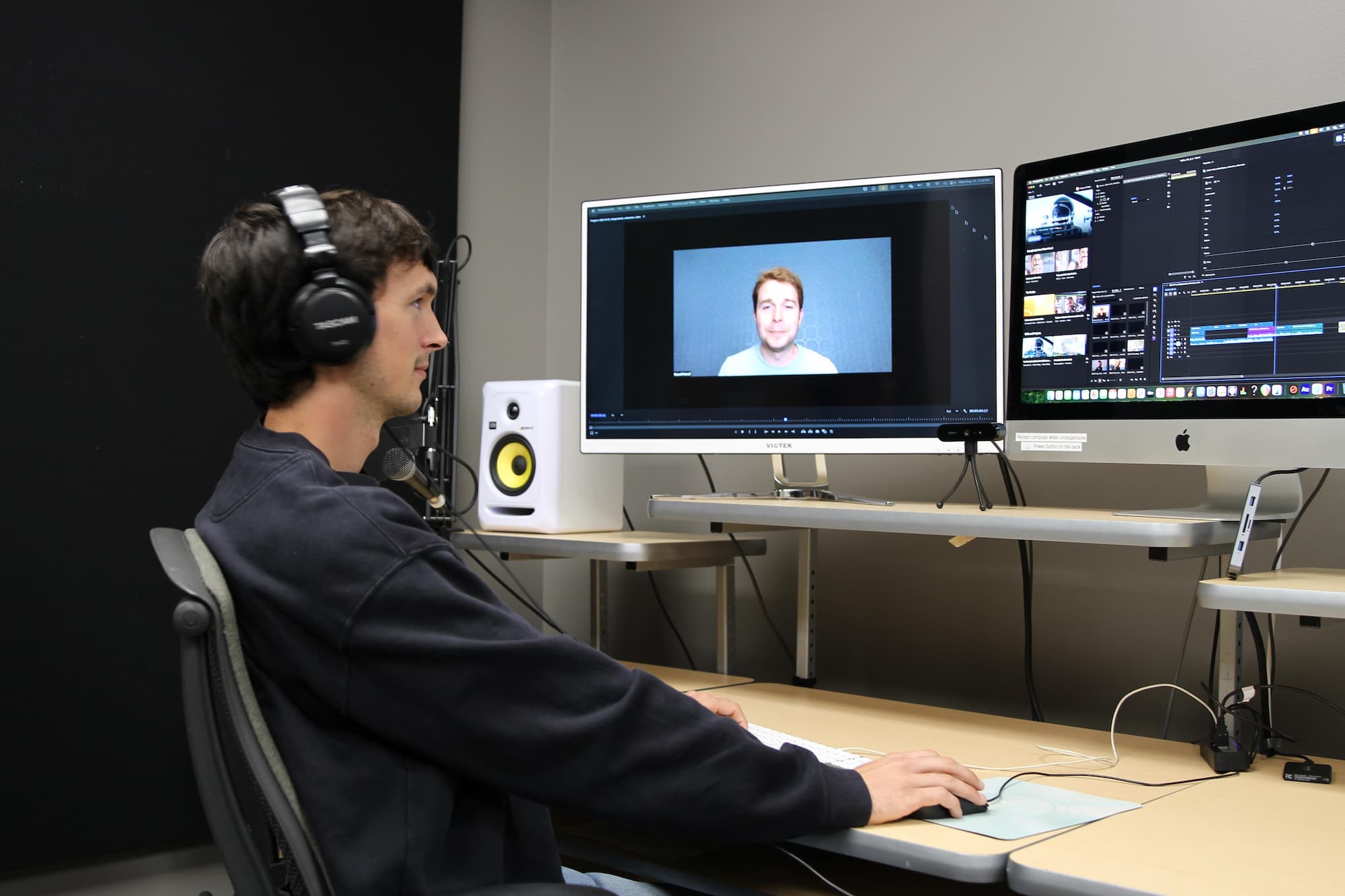 one person sitting in front of a computer and editing his film in Adobe Premiere Pro