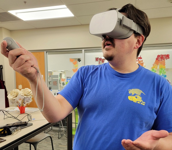 man wearing a VR headset and holding controller